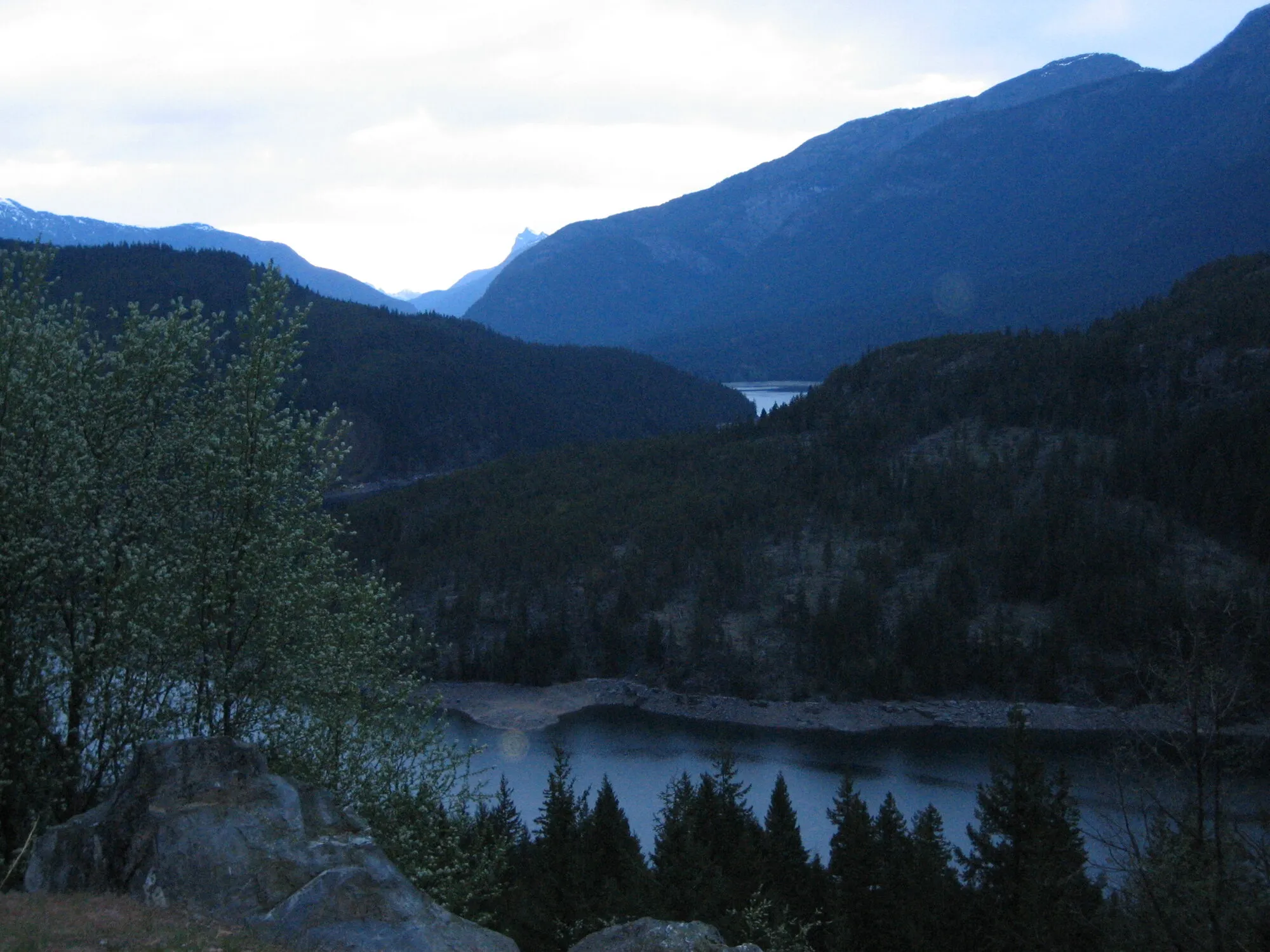 Dark forested mountains above a lake at dusk in North Cascades National Park