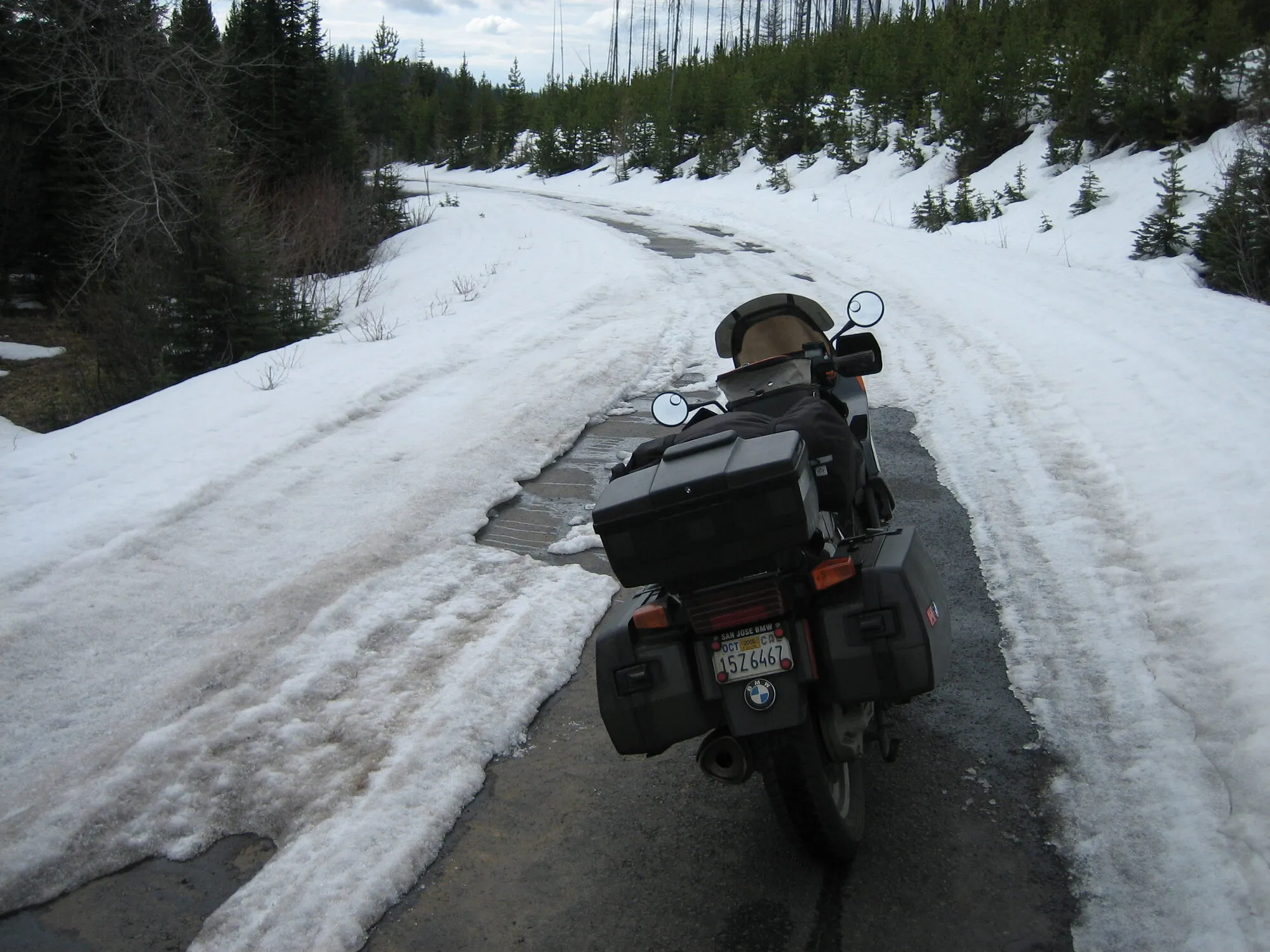 The loaded BMW parked on a road buried in snow on Wallowa Mountain Road